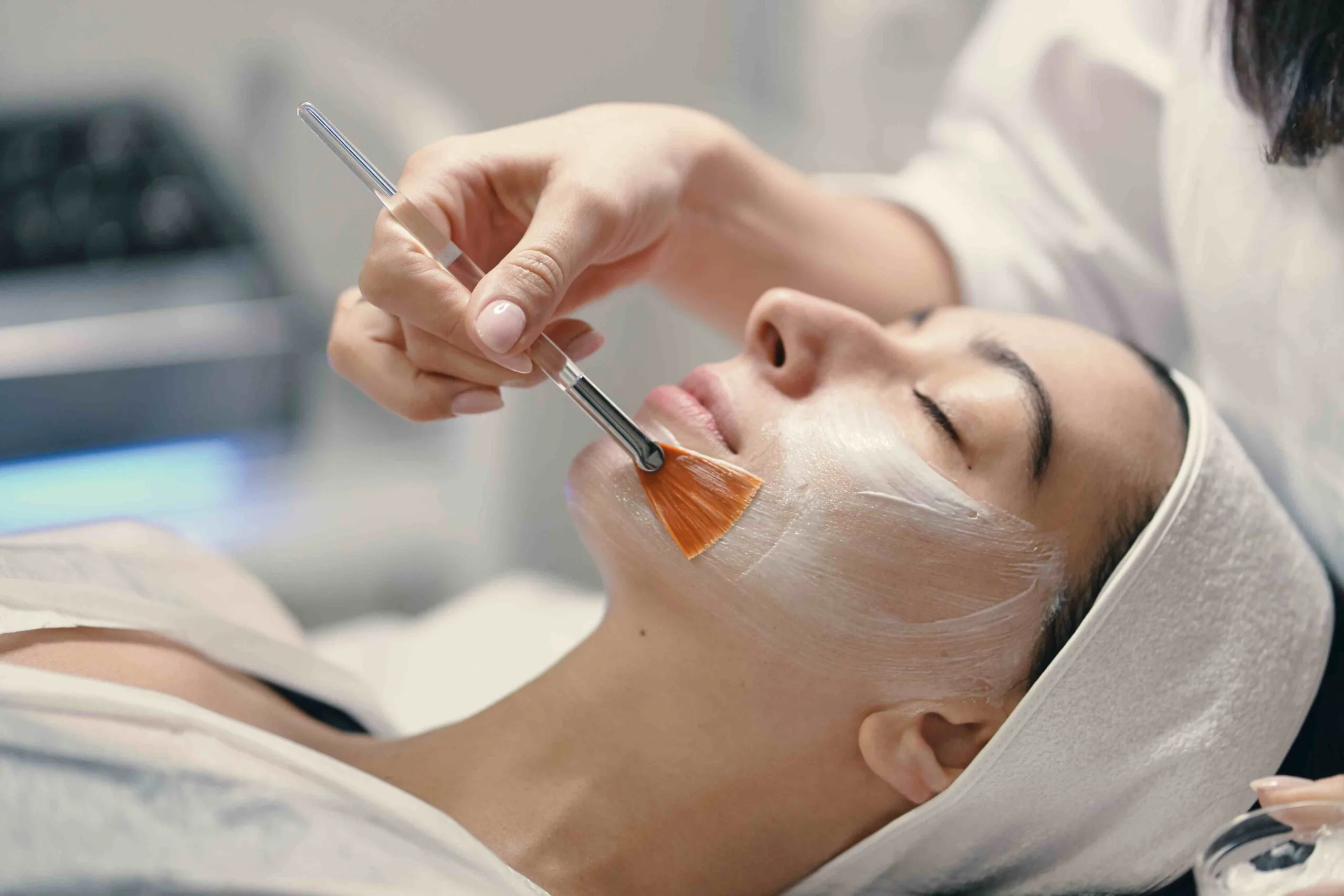 a woman is applying face mask