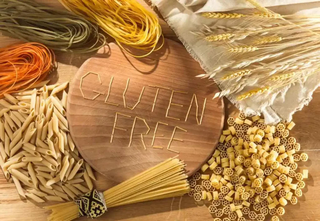 Gluten free food. Various pasta, bread and snacks on wooden background from top view